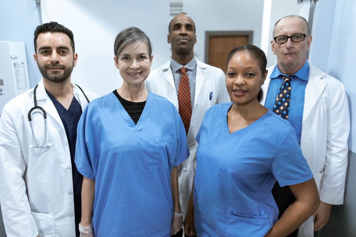 A team of healthcare and support staff standing together