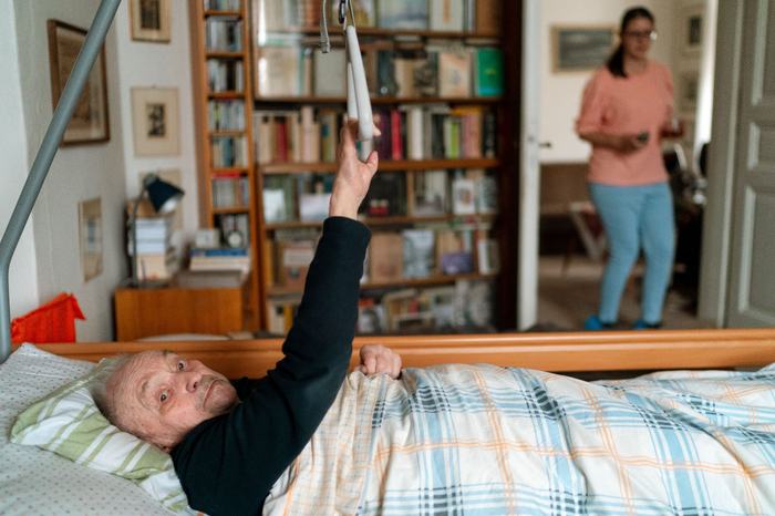 In-home carer supporting an elderly patient